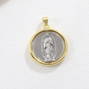 Close-up of a two-tone 18k gold plated spinning Guadalupe religious pendant with silver details