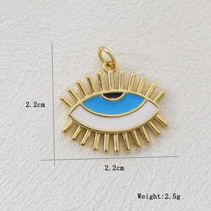 Detail of 18k gold plated evil eye pendant showing 2.2cm size and 2.5g weight