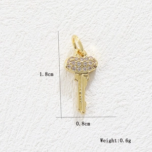 Detailed macro view of 18k gold heart key pendant with dimensions 1.8cm x 0.8cm and 0.6g weight
