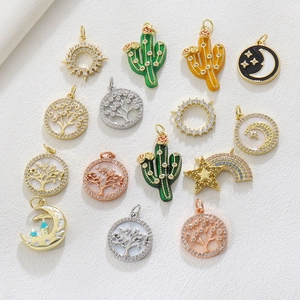 Macro shot of assorted enamel pendants with tree of life, cactus, and star moon charms