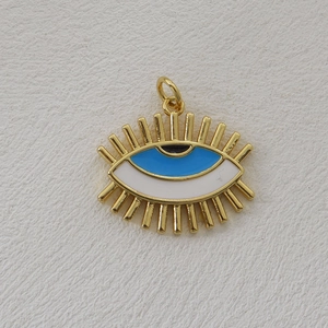 Macro shot of 18k gold-plated evil eye cross pendant with blue and white enamel detail