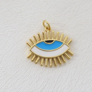 Close-up of a blue and white evil eye charm with 18k gold plating for jewelry making