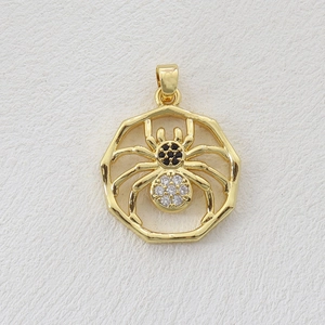 Macro shot of gold plated spider pendant with black and white cubic zirconia stones