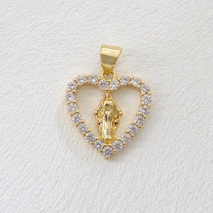 Detailed macro of 18k gold plated heart pendant with Virgin Mary relief and zircons