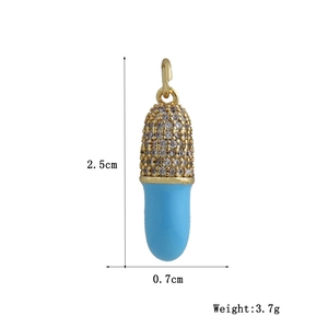 Detail of 18k gold capsule pendant with micro-inlaid crystals and blue enamel finish