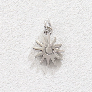 Detailed macro view of silver sun pendant with spiral center and wavy rays