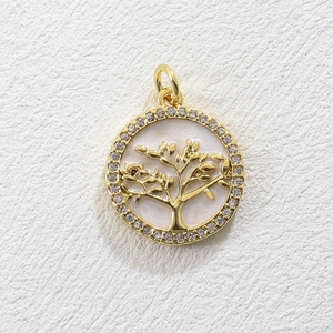 Macro detail of Tree of Life pendant with gold plating and sparkling zircon border
