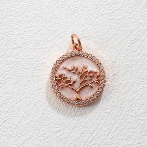 Macro shot of rose gold Tree of Life pendant with pink enamel and sparkling crystals