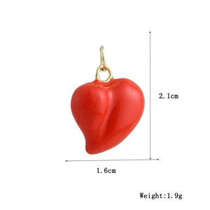 Macro shot of 18k gold plated red heart pendant with dimensions 2.1x1.6cm and weight 1.9g