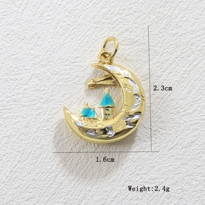 Macro detail of moon and castle pendant with blue enamel and star 2.3cm height