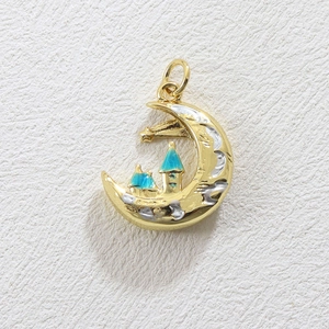 Detailed view of a gold-plated moon pendant featuring a blue castle and star elements