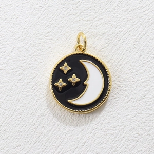 Detailed view of round celestial charm with black enamel, golden stars and crescent moon