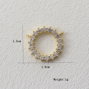Detail of round gold pendant with white zircons showing 1.5cm diameter and 1g weight