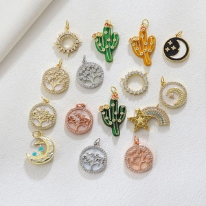 Macro view of assorted charm pendants including tree of life and cactus for DIY jewelry