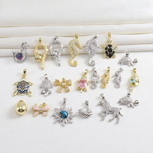 Macro view of assorted 18k gold plated sea life pendants with sparkling zircons