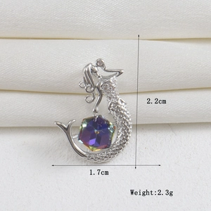 Detail shot of mermaid pendant showing 2.2cm height and 1.7cm width dimensions