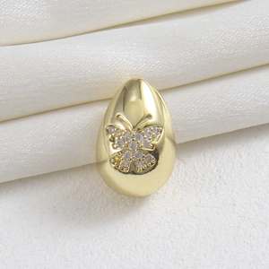 Detailed view of an 18k gold plated egg-shaped pendant featuring a micro-set zircon butterfly