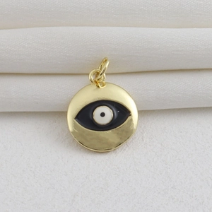 Detalle de colgante de ojo turco chapado en oro 18k con textura martillada en seda