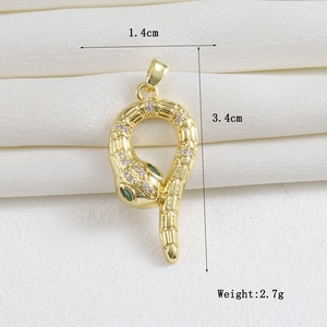 Detail view of 18k gold snake pendant with green gemstone eyes and white cubic zirconia