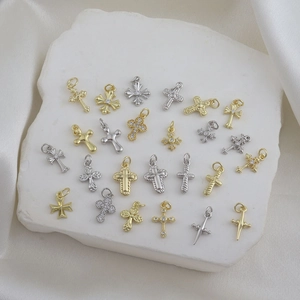 Detailed flat lay of diverse gold and silver cross pendants for DIY jewelry design