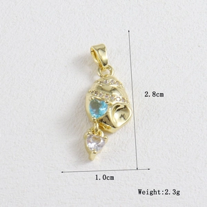 Macro detail of gold-plated heart pendant with blue zircon stones and size dimensions