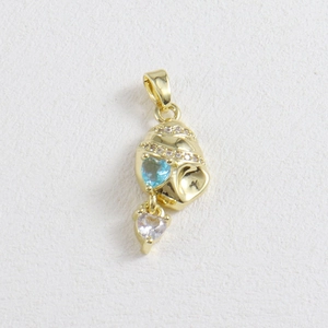 Detailed view of 18k gold conch pendant with heart gemstones and sparkling crystals
