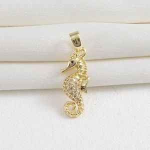 Elegant 18k gold plated seahorse pendant with shimmering cubic zirconia and black gemstone eye