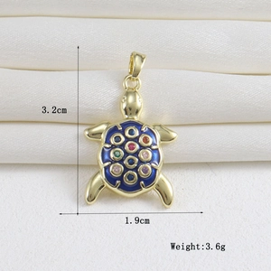 Detailed view of turtle pendant with 18k gold plating and multi-color crystal inlay