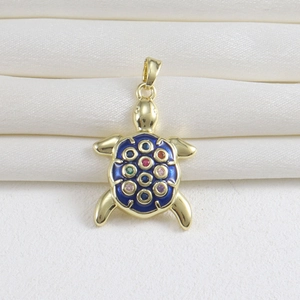 Detailed view of a turtle pendant with gold finish, blue enamel, and colorful gemstones