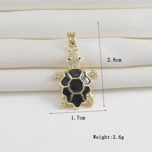 Detailed view of turtle pendant with gold plating, black enamel shell and white zircons