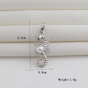 Detailed silver seahorse pendant with white pearl and green gemstone eye, size 2.5cm by 0.9cm