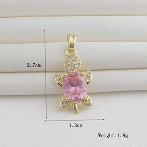Macro shot of 18k gold plated turtle pendant with pink stone and measurement details
