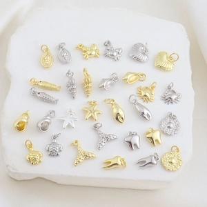 Detailed view of assorted gold and silver sea animal charms for DIY jewelry making