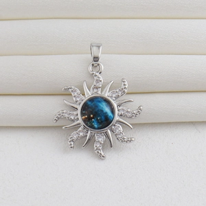 Detailed view of silver sun pendant with a blue nebula center and sparkling crystals