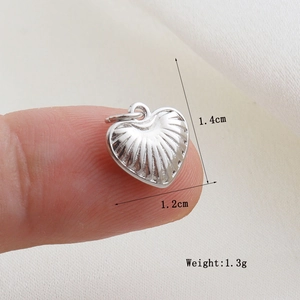 Detailed size view of silver heart pendant measuring 1.4cm by 1.2cm with 1.3g weight