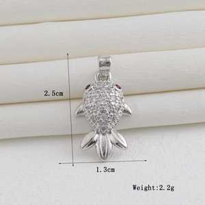 Detailed view of silver fish pendant with white zircons and size markings 2.5cm by 1.3cm