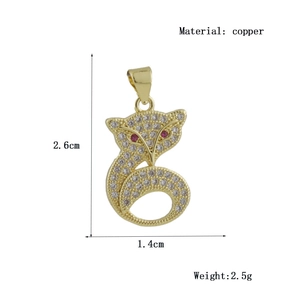 Detailed view of fox pendant in gold-plated copper with white zircon and red eyes