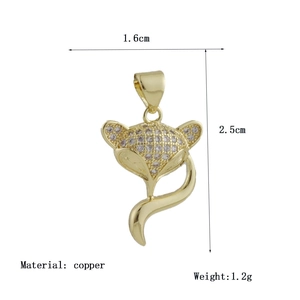 Detailed macro view of a gold fox pendant with cubic zirconia inlay and 1.6x2.5cm size