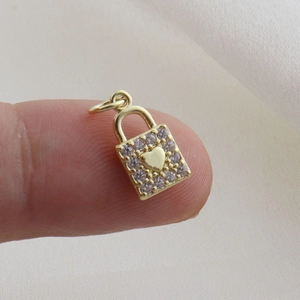 Detailed view of a gold-plated heart lock pendant with sparkling cubic zirconia accents