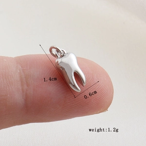 Polished silver tooth-shaped charm measuring 1.4cm by 0.6cm for DIY jewelry making