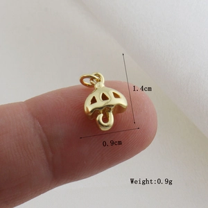 Detailed view of small gold umbrella pendant with measurements 1.4cm height and 0.9g weight