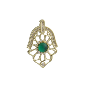 Detailed close-up of golden Hamsa pendant with green gemstone and white crystal accents