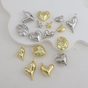Macro shot of gold and silver heart and starfish metal charms for DIY jewelry making