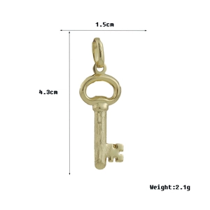 Detail view of a gold key pendant with dimensions 4.3x1.5cm and weight 2.1g on white background