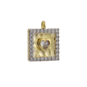 Macro shot of a square mixed-metal pendant with zircon halo and gold heart center