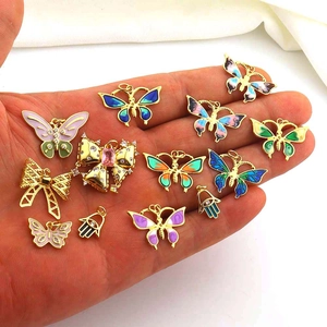 Detail of colorful enamel butterfly pendants and Hamsa hand charms for DIY jewelry