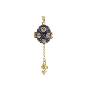 Detalle del colgante de huevo esmaltado azul estilo Fabergé con ángel de oro y circonio