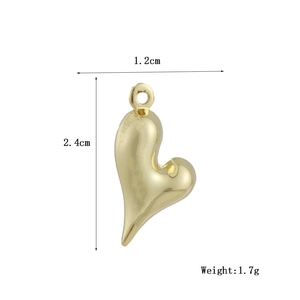 Macro shot of gold heart pendant with dimensions 1.2cm by 2.4cm and 1.7g weight
