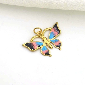 Detail of a gold butterfly charm with blue and pink enamel for DIY jewelry making