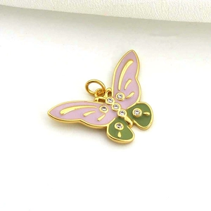 Macro detail of butterfly pendant with purple enamel wings and zircon stones